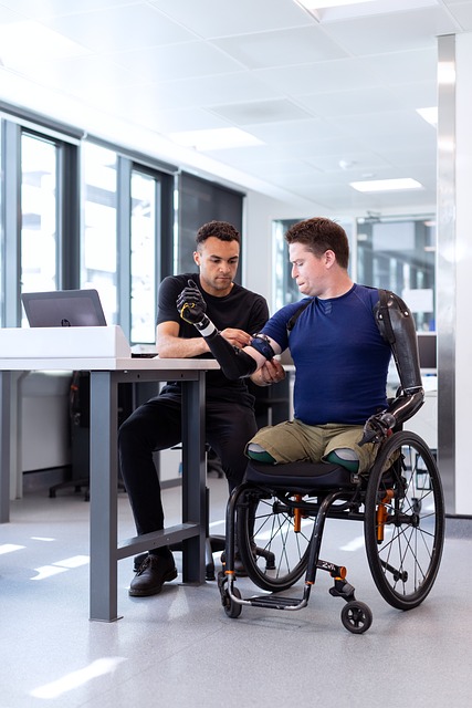 Two men work together on a prosthetic limb in an office